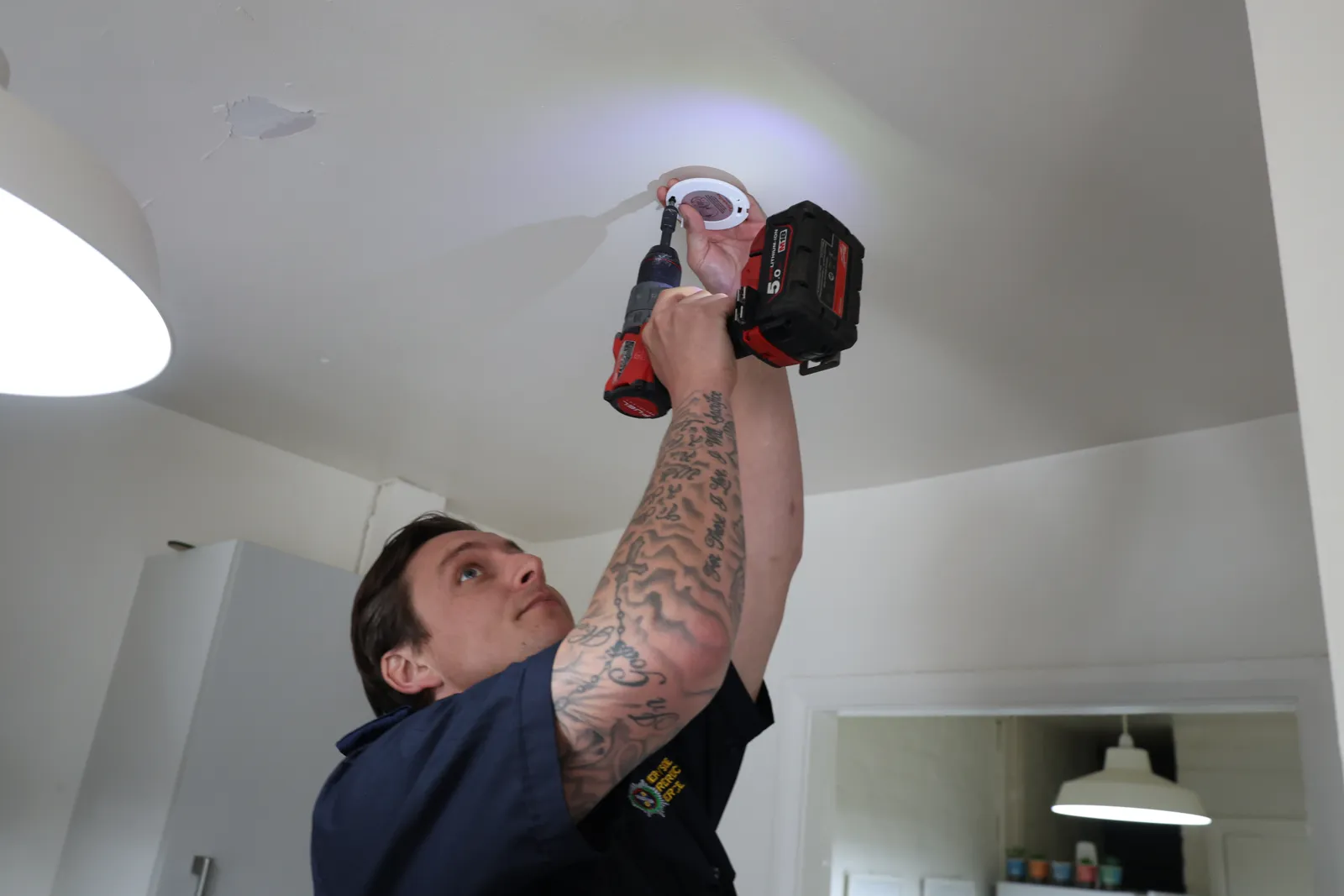 A smoke alarm being fitted on a Merseyside Fire and Rescue Service home safety visit. The service published this photograph with its update on the Bootle reassurance campaign.
